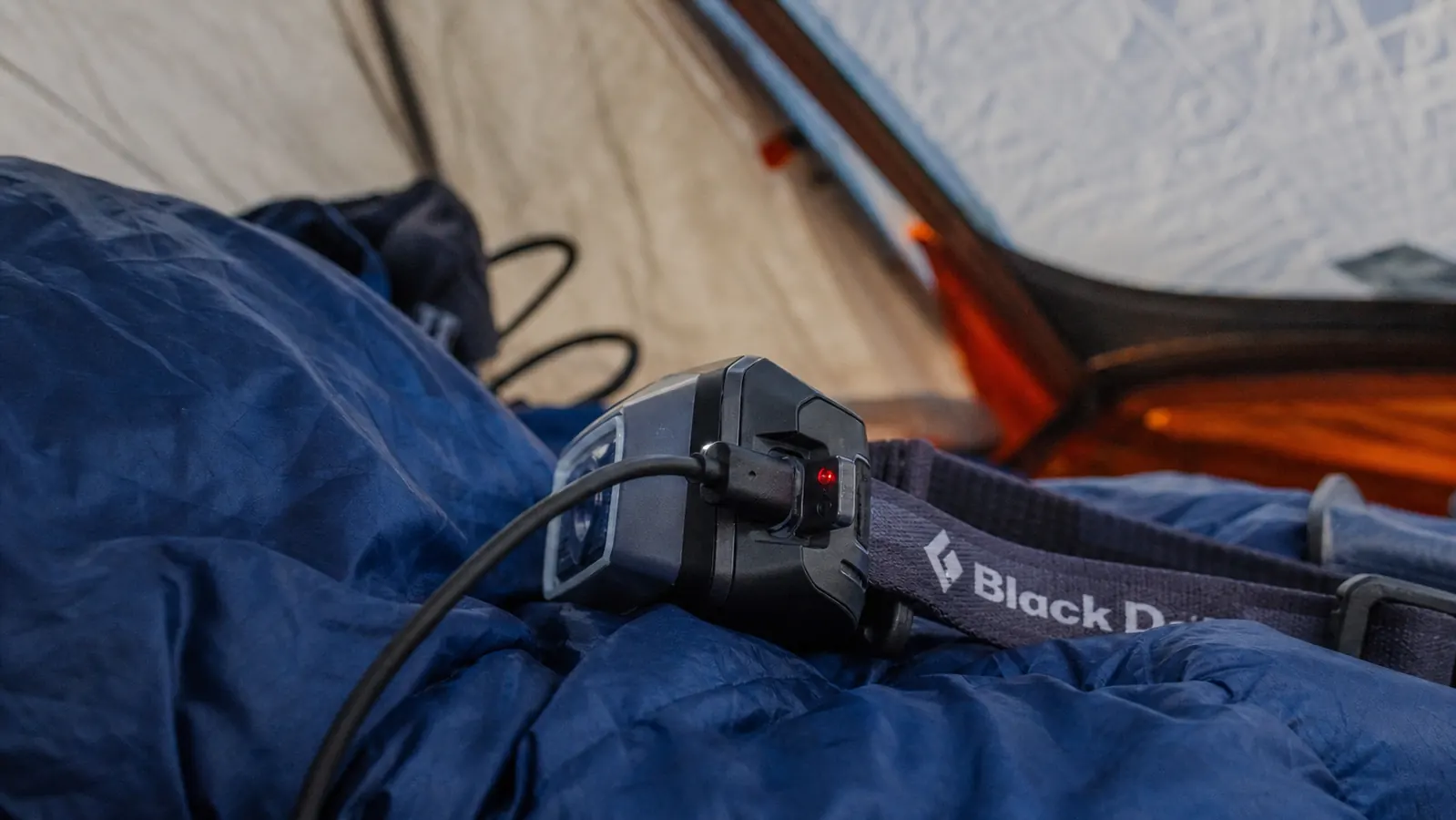 Camper using the LHKNL headlamp during a night hike on a rocky trail, beam pointed at the path ahead